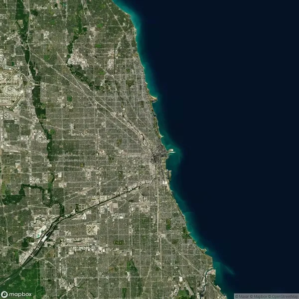 Satellite view of Chicago, showing a dense urban grid adjacent to the dark blue waters of Lake Michigan.