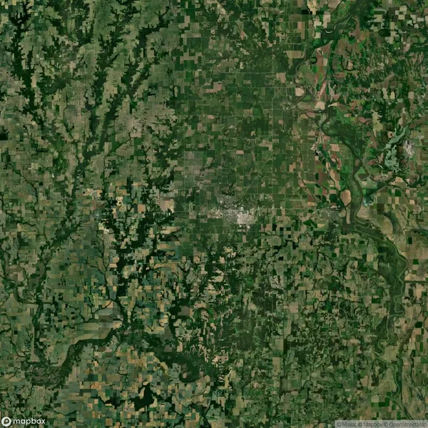 Aerial view of a rural landscape featuring a patchwork of agricultural fields, forests, and rivers.