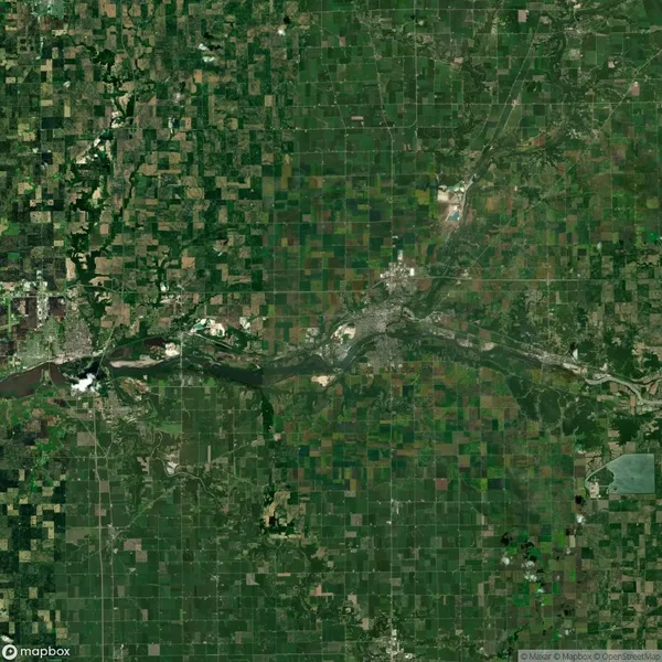 Satellite image of a large, rectangular grid of farmland surrounding a winding river and patches of forested areas. Roads and small settlements are visible throughout the landscape.