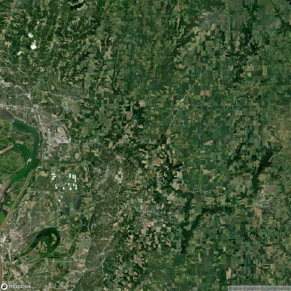 Aerial view of a landscape featuring a mix of urban areas, agricultural fields, and a river. The left side shows a dense urban area, while the right side is dominated by green farmland.