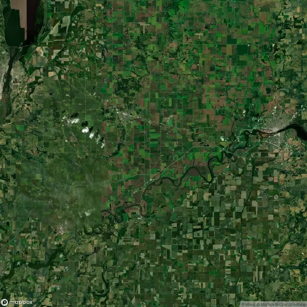 Satellite view of a green and brown patchwork landscape with fields, a winding river, and scattered settlements.