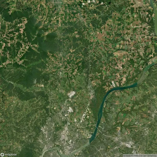 Satellite image showing a river winding through a varied landscape of forests, fields, and urban areas. Vegetation appears in different shades of green, with patches of brown and gray.