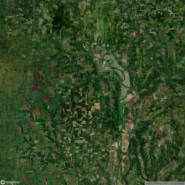 Aerial view of a landscape featuring a patchwork of agricultural fields, winding river, and scattered wooded areas.