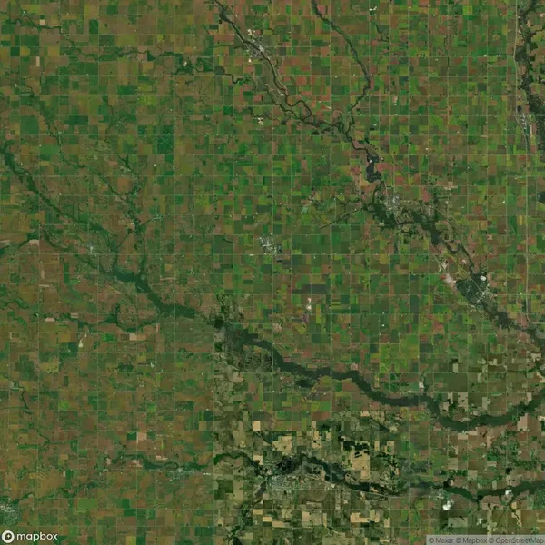 Aerial view of a green and brown patchwork of agricultural fields with scattered rivers and roads.