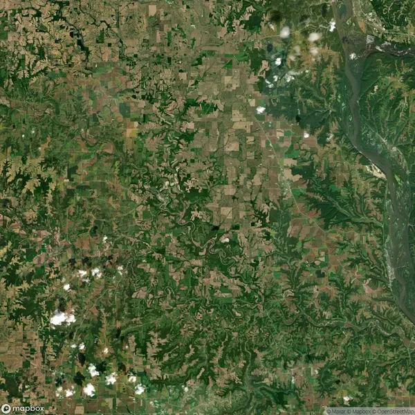 Aerial view of a landscape with a mix of fields, forests, and rivers winding through the area, with some clouds visible above.