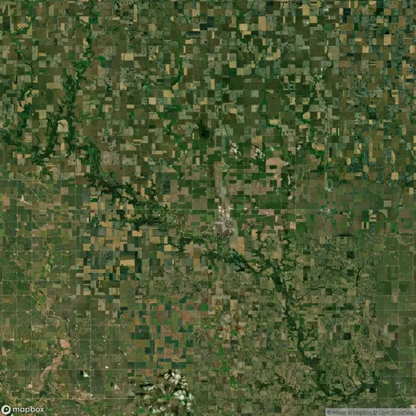 Aerial view of a patchwork landscape showing a grid of agricultural fields and natural vegetation, intersected by rivers and roads.
