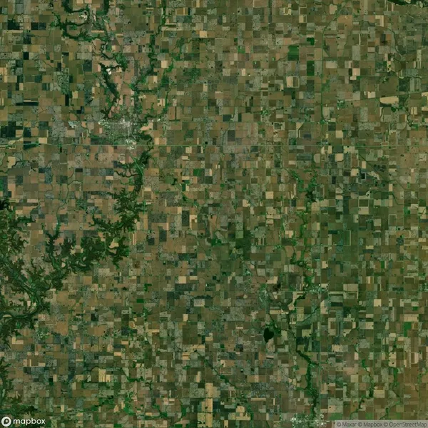 Satellite image of a vast patchwork of agricultural fields with a river winding through the landscape.