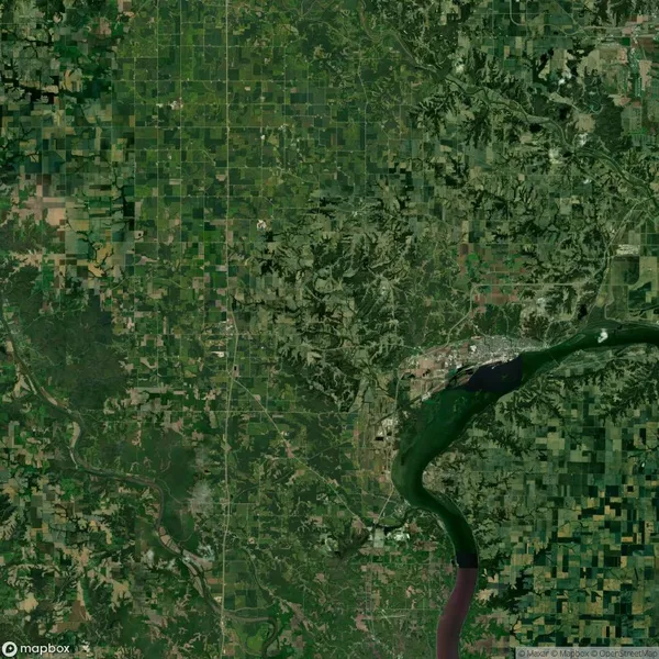 Satellite view of a landscape featuring a winding river, surrounding greenery, and a small section of urban development. Grid-like patterns of farmland are visible across the landscape.