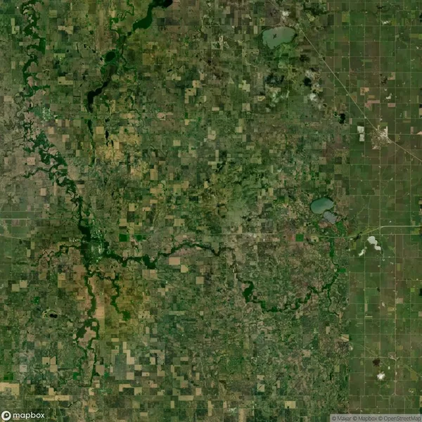 Aerial view of a large, flat agricultural landscape with patchwork fields, green vegetation, small lakes, and winding rivers.