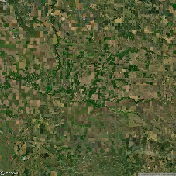Aerial view of a patchwork landscape of agricultural fields and winding rivers in a rural area.