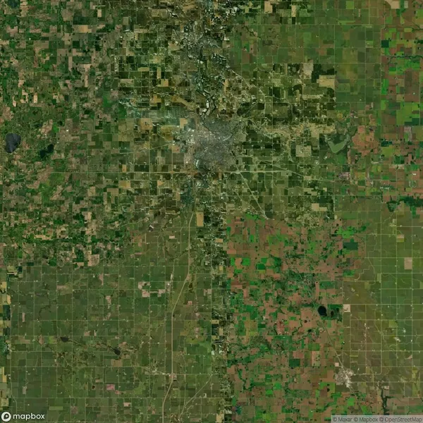 Aerial view of Lubbock, Texas, showing a grid of agricultural fields surrounding the urban area in the center.
