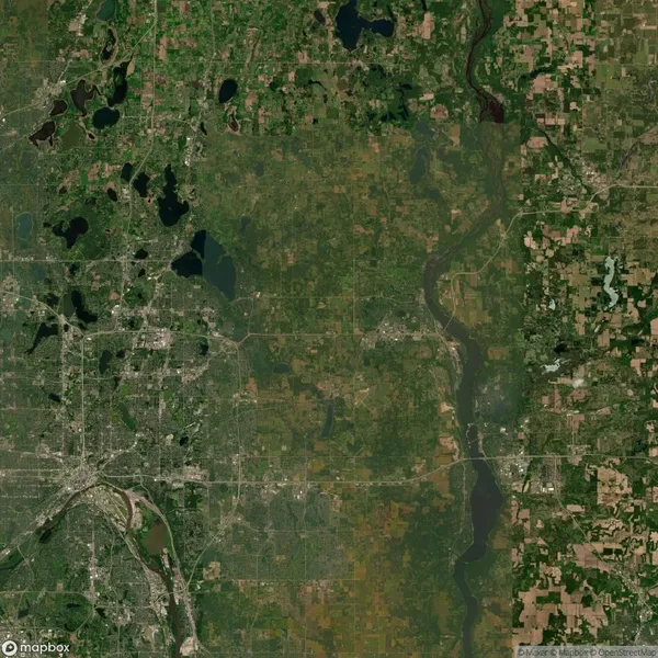 Satellite view of a landscape showing urban and rural areas with rivers, roads, and patches of greenery.
