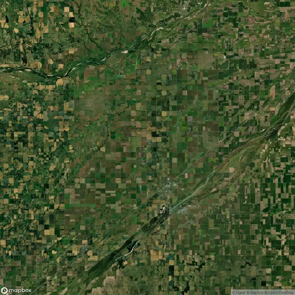 Aerial view of a vast landscape with a patchwork of agricultural fields, rivers, and forested areas.