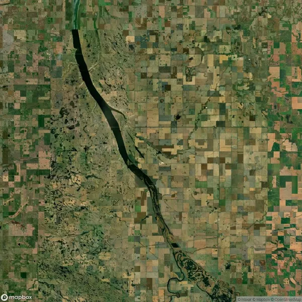 Satellite image of a region with a river cutting through a patchwork of agricultural fields.