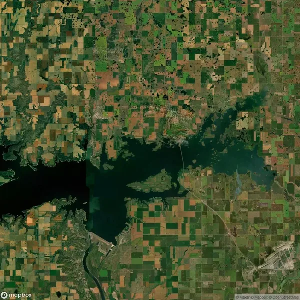 Aerial view of a large body of water surrounded by patchwork fields and roads.