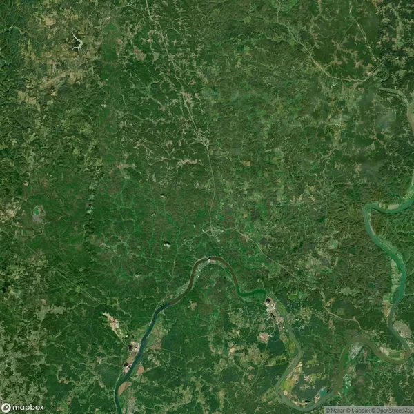 Satellite view of a green landscape with winding rivers, roads, and scattered small towns. An airplane is visible in the upper left corner.