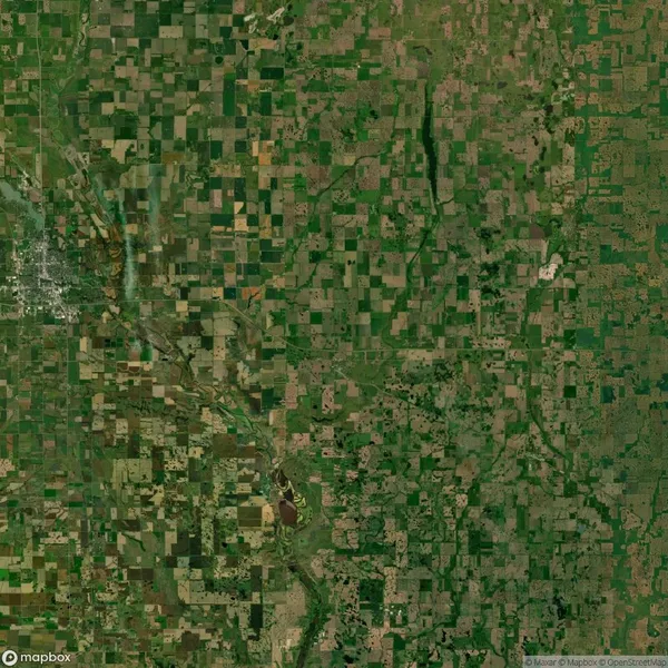 Aerial view of a rural landscape with a patchwork of farmland fields, rivers, and scattered vegetation.