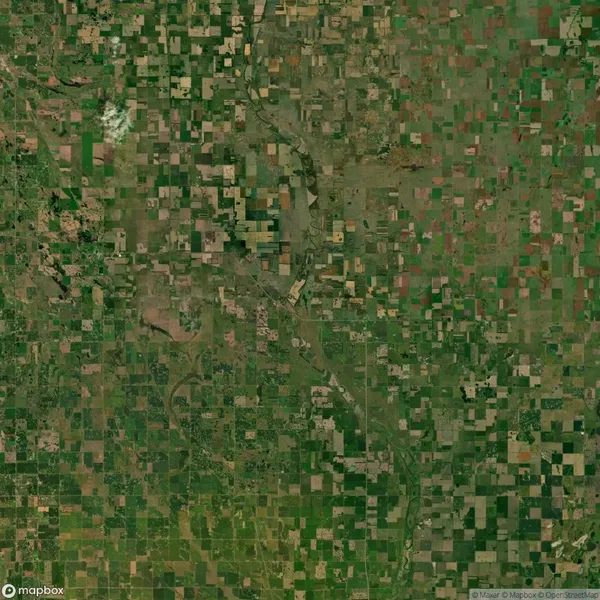 Aerial view of a vast landscape with numerous rectangular agricultural fields and a winding river cutting through the terrain.