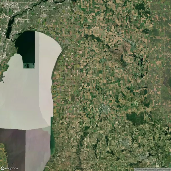 Satellite view of a region showing a large lake on the left and a patchwork of agricultural fields and urban areas on the right.