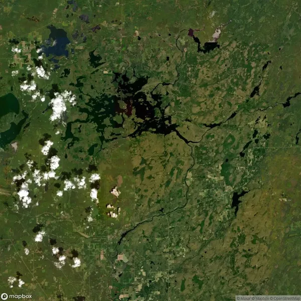 Satellite view of a green landscape with scattered clouds and various bodies of water, including lakes and rivers, on the left side.