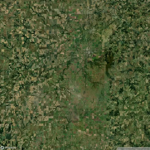 Aerial view of a patchwork landscape with irregular fields, small forests, winding rivers, and scattered rural settlements.
