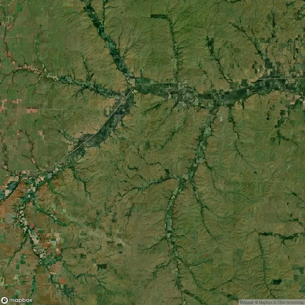 A satellite view shows a rural landscape with fields, intersecting rivers or streams, and patchy vegetation patterns across the area.