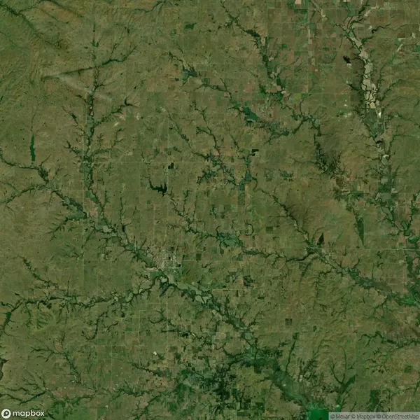 Aerial satellite view of a rural landscape with patchwork fields, rivers, and natural vegetation patterns visible across the area.
