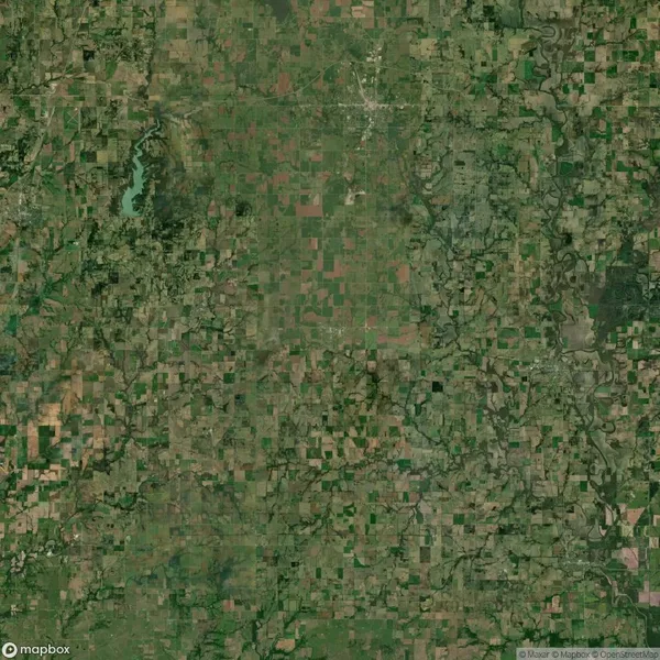 Aerial view of a rural landscape with a patchwork of agricultural fields, roads, rivers, and small forested areas.