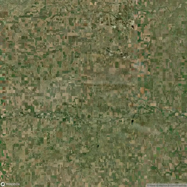 Aerial view of a rural landscape with a patchwork of agricultural fields and a winding river running through the center.