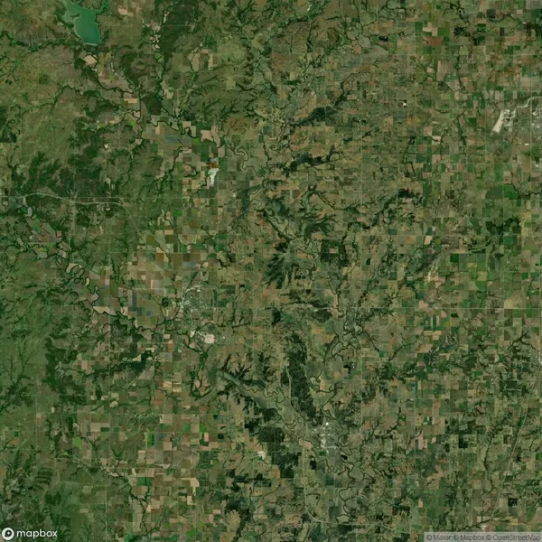 Satellite image showing a rural landscape with a mix of farmland, forests, river valleys, and scattered small communities.